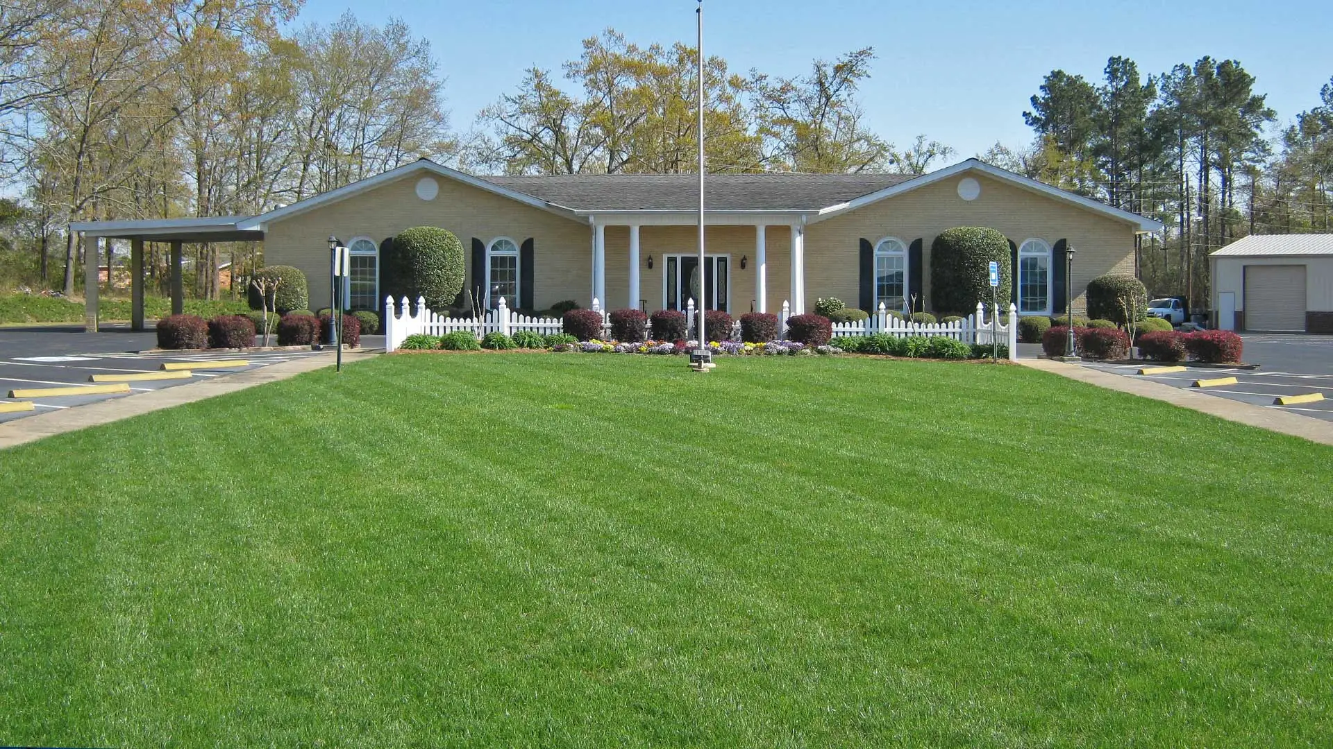 Commercial building in Waynesboro recently mowed, professional landscaping, and annual flower plantings.