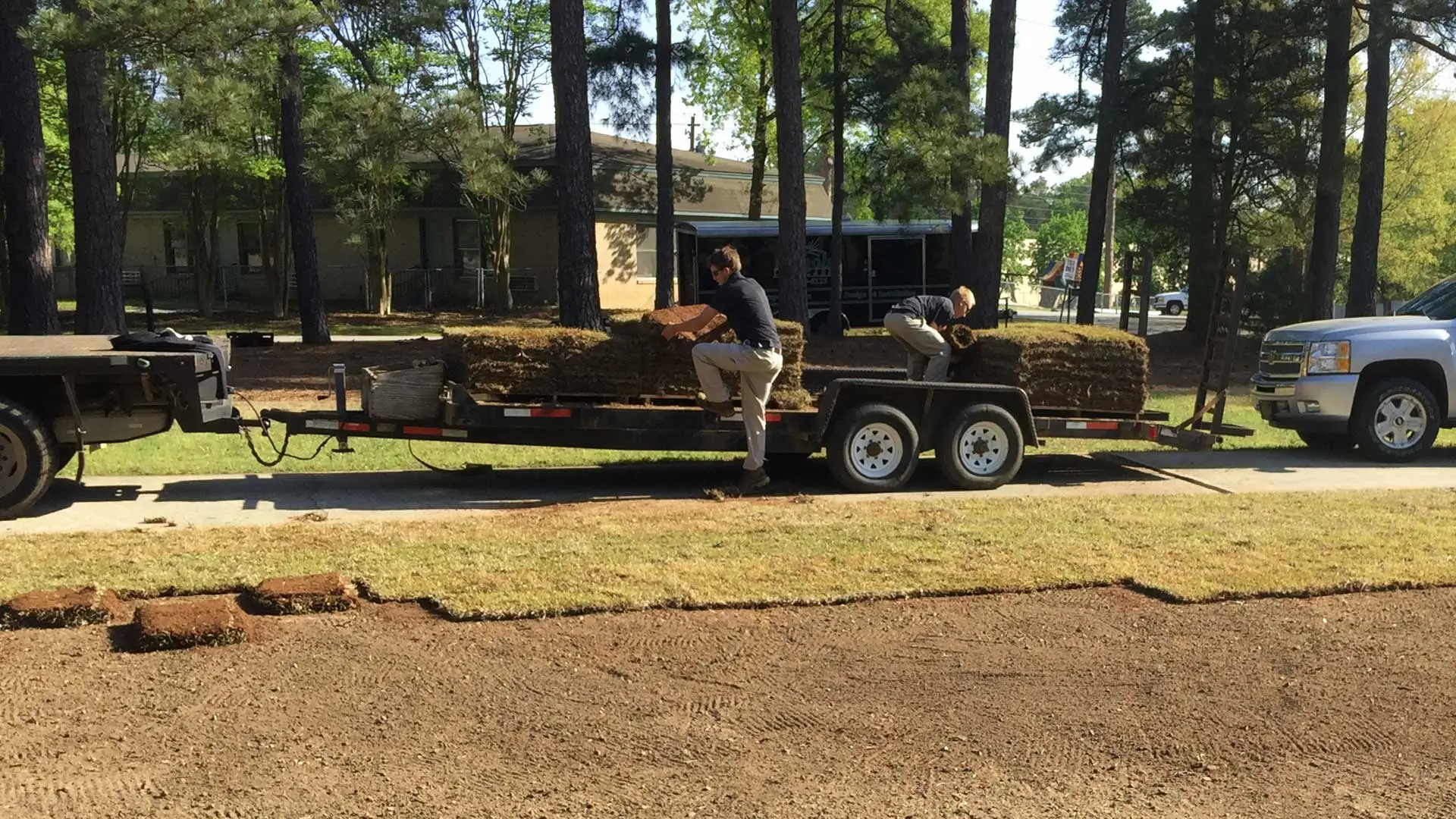 Nichols Lawn Care employees laying new mulch at a home in Waynesboro, GA.