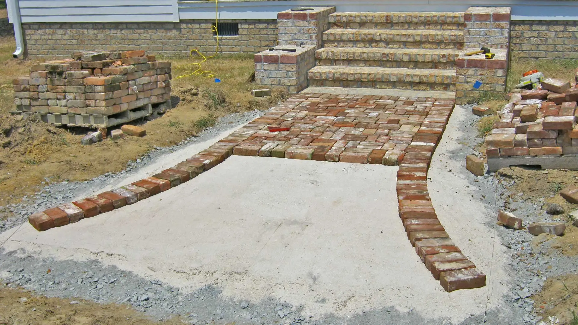 New hardscaping pathway and steps built with pavers in front of a home in Wrens.