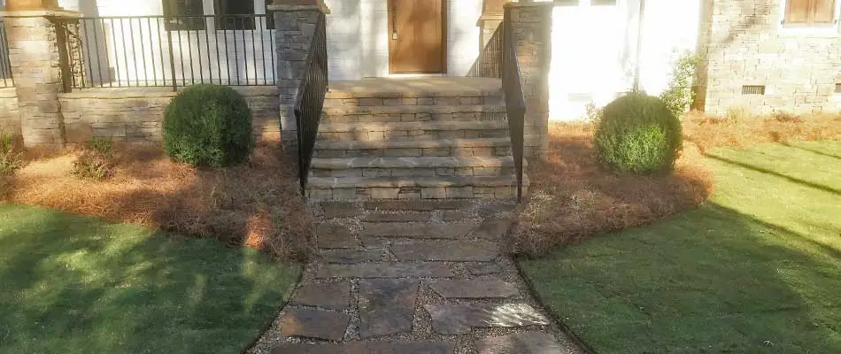 New steps and walkway in front of a Louisville, GA home created with natural stone pavers.