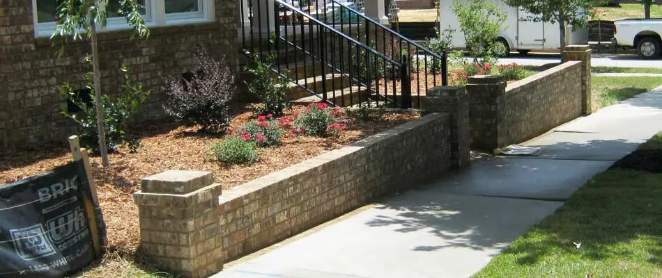 Retaining wall in front of a home in Wrens, GA with new landscape installation.